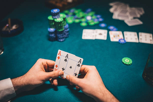 Image of a confident man showcasing a winning hand with two aces